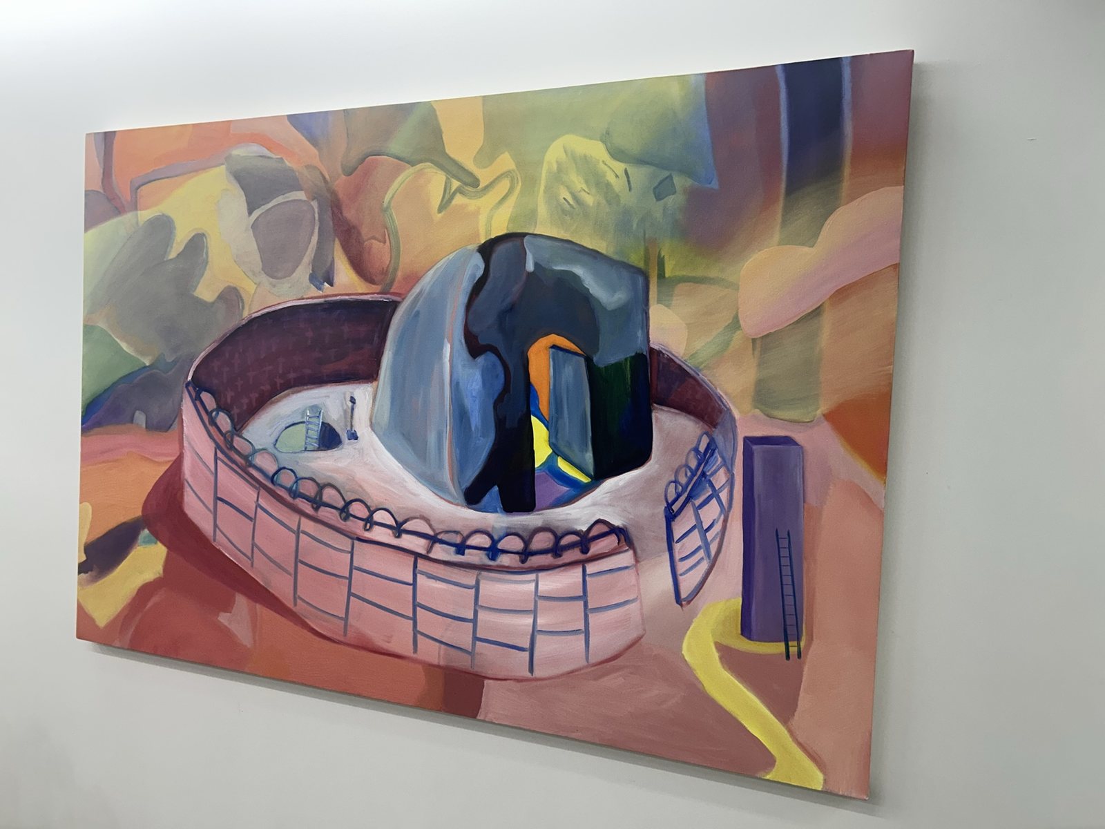 A colorful painting of a round arena on the wall