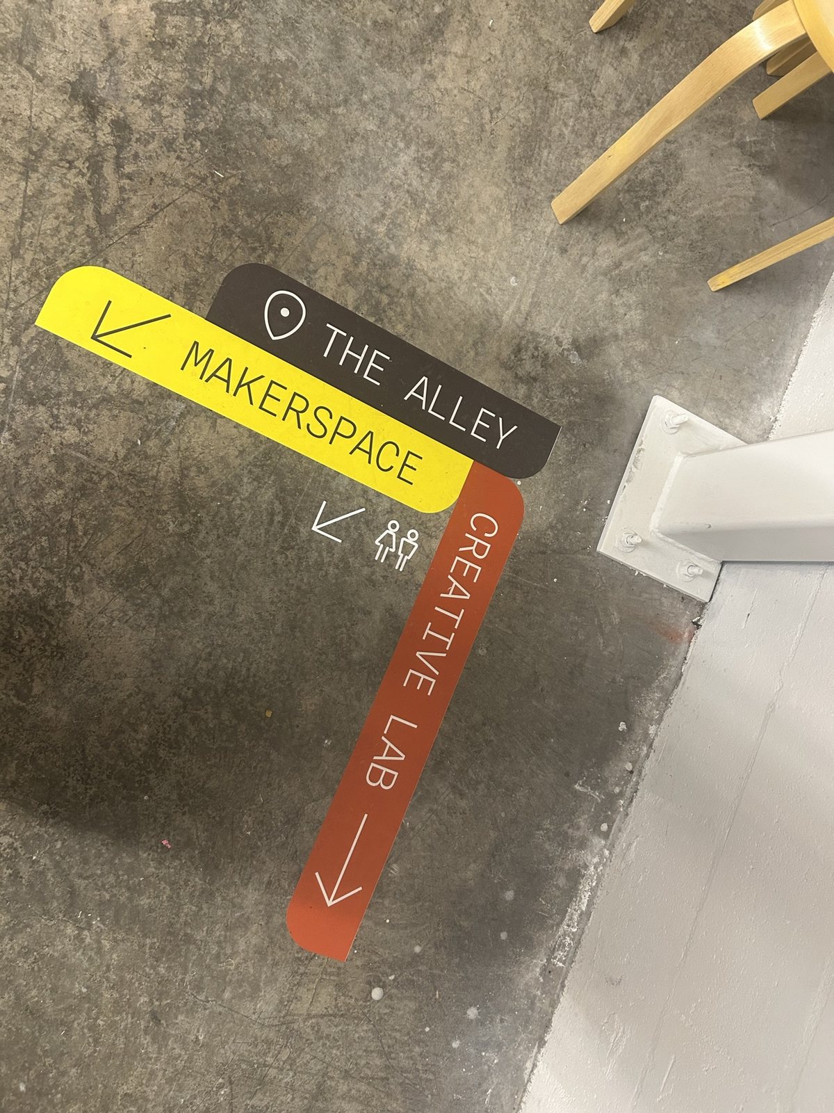 Floor decals pointing to The Alley, Makerspace and Creative Lab