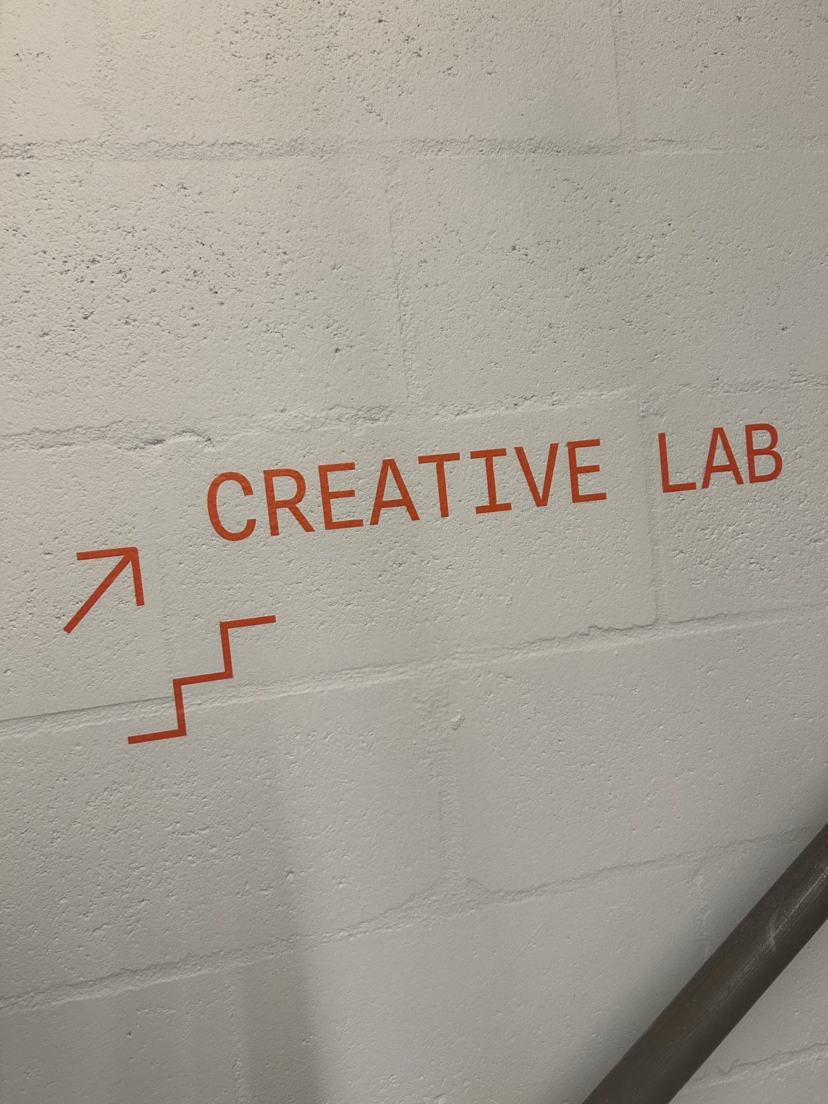 A "Creative Lab" sign painted on the wall