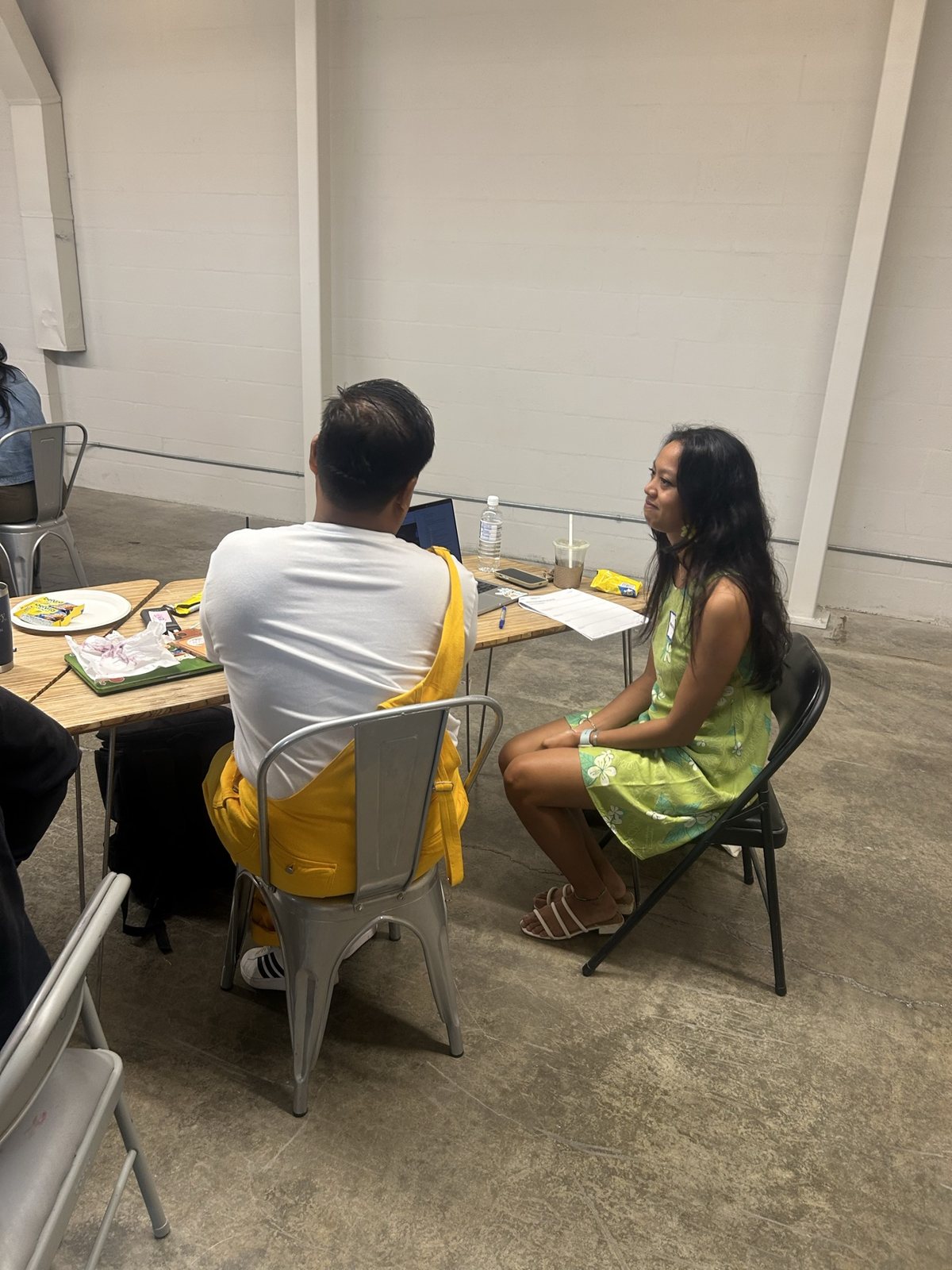 Two attendees in conversation at a table