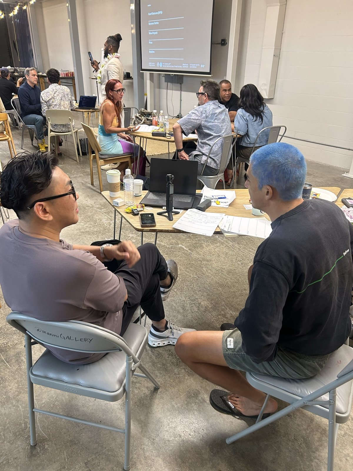 Two attendees talking at a table