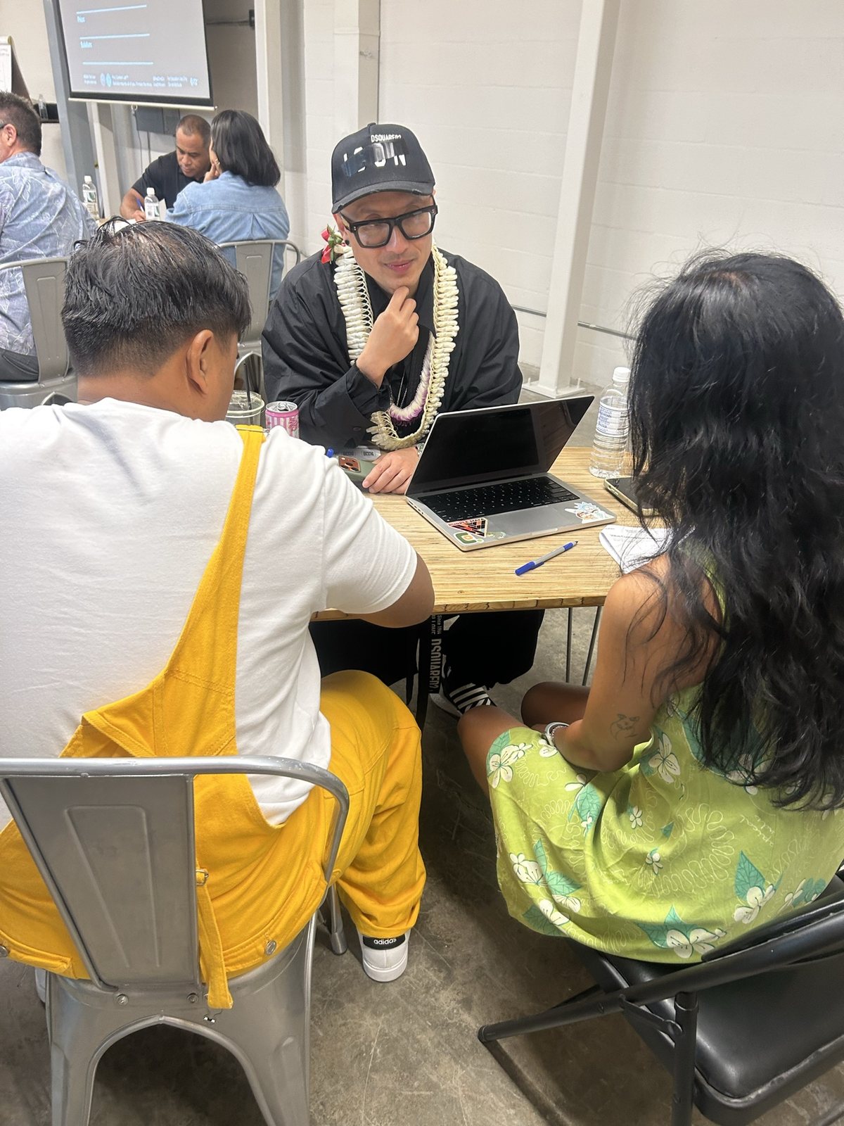 Chris Do going through a worksheet with two attendees