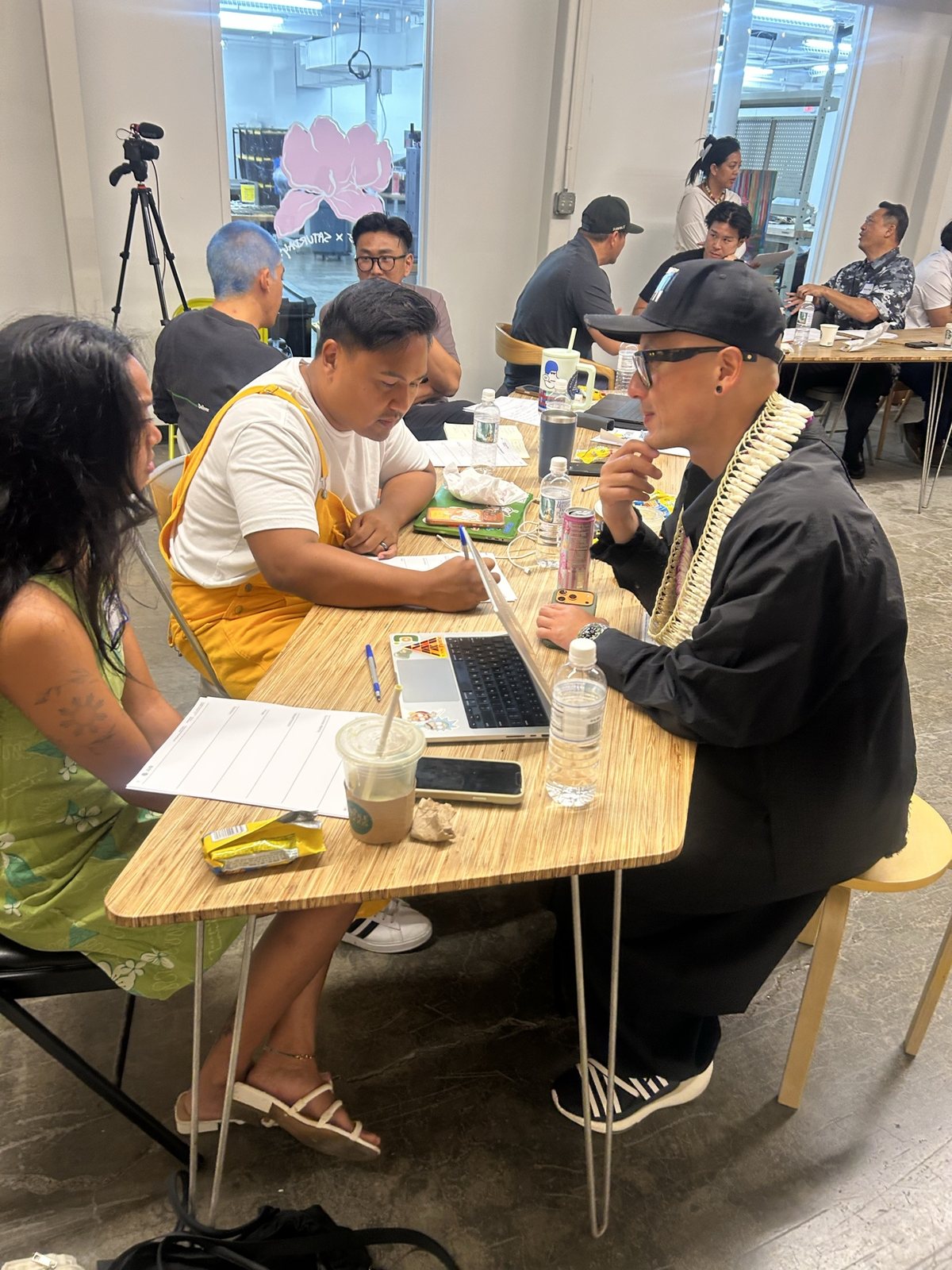 Two attendees and the facilitator at a small table