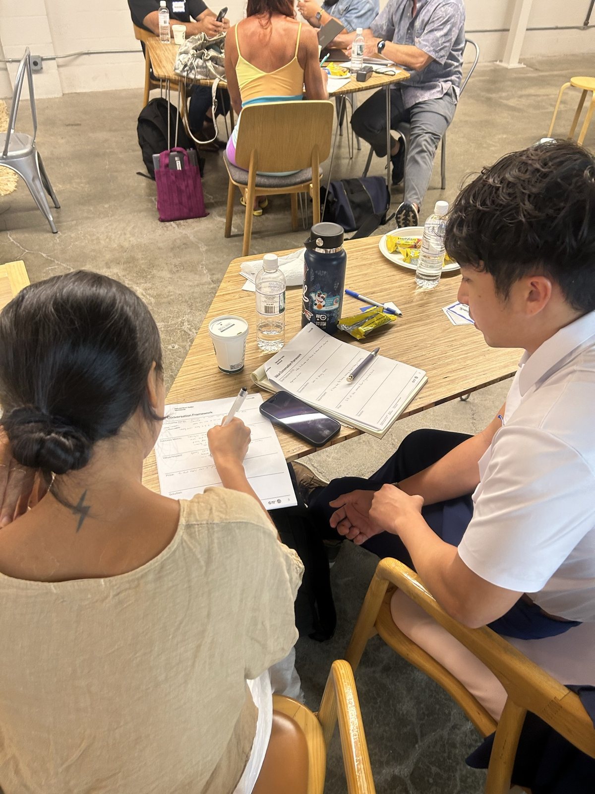 An attendee writing on her worksheet