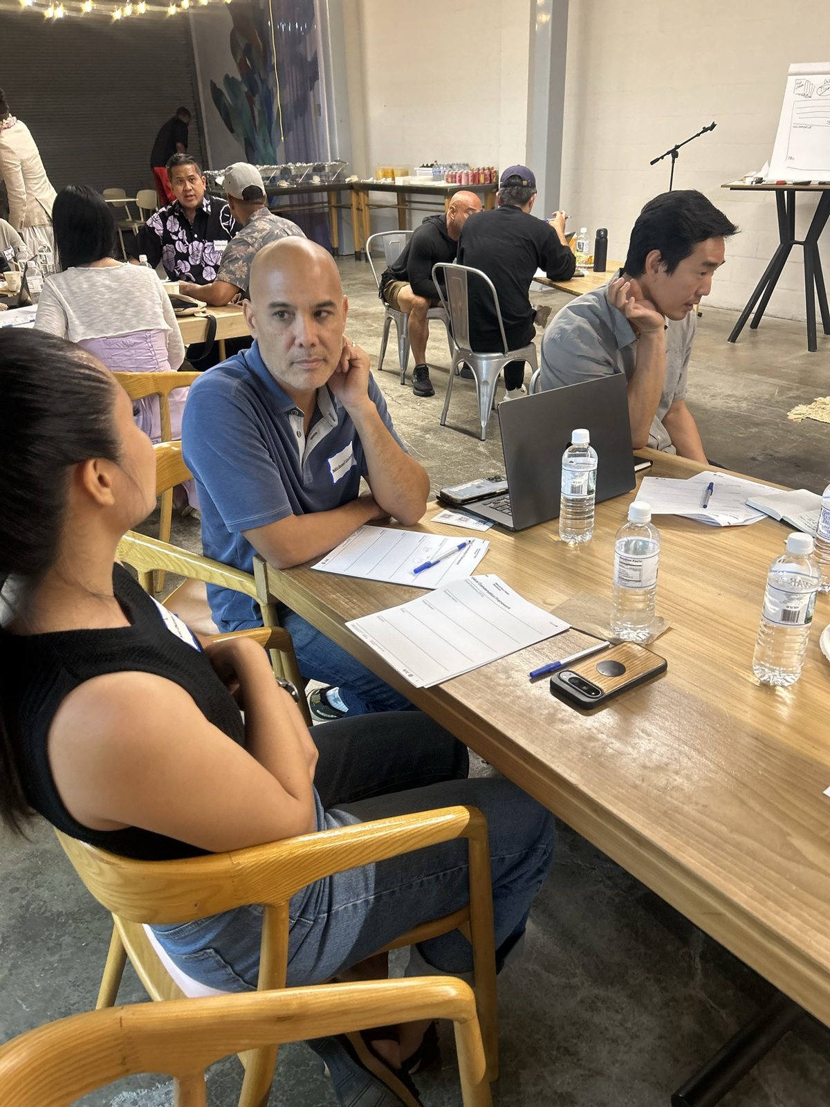 A man and a woman talking across a long table