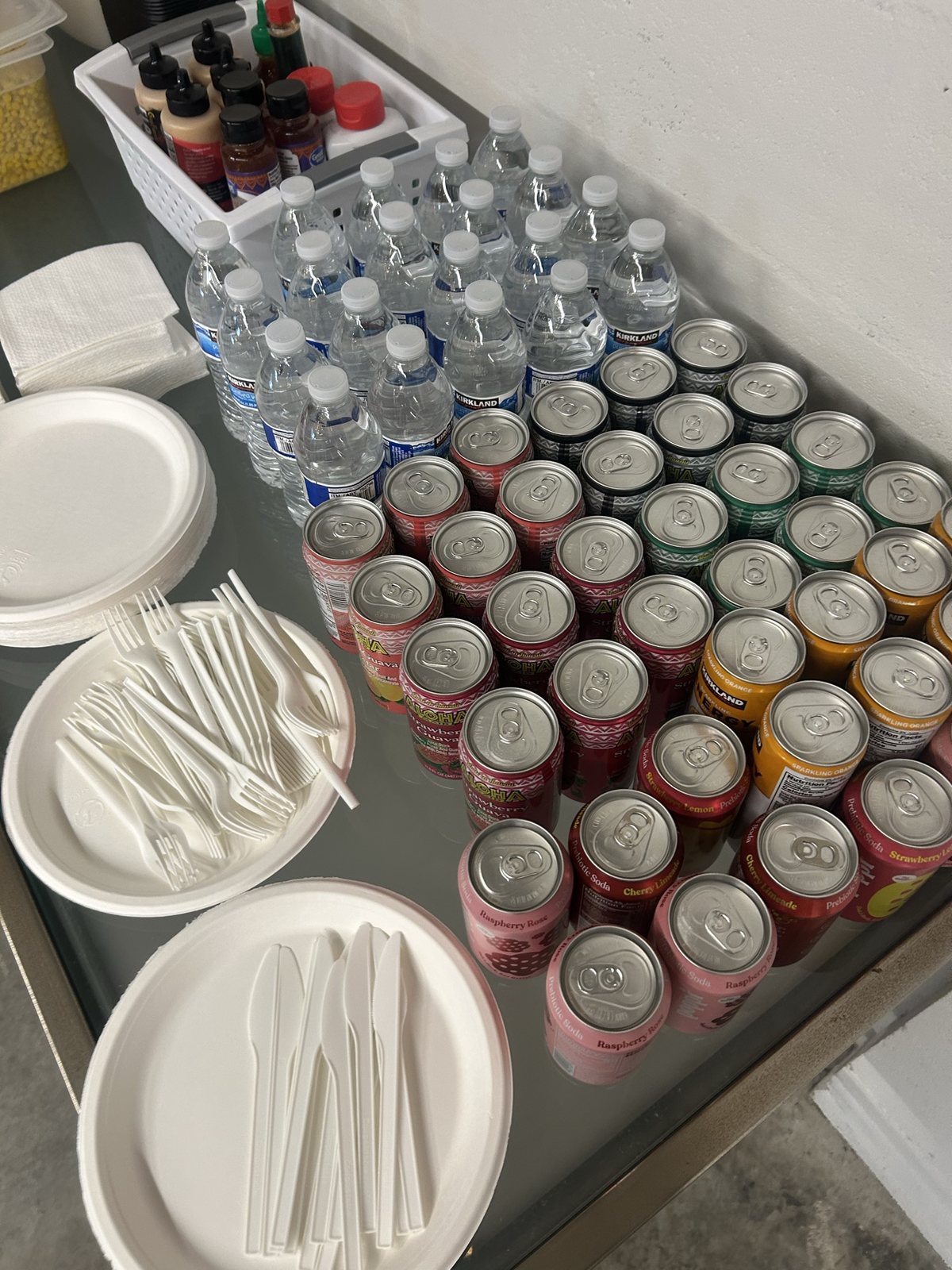 Water, cans, plates and utensils laid out for the break