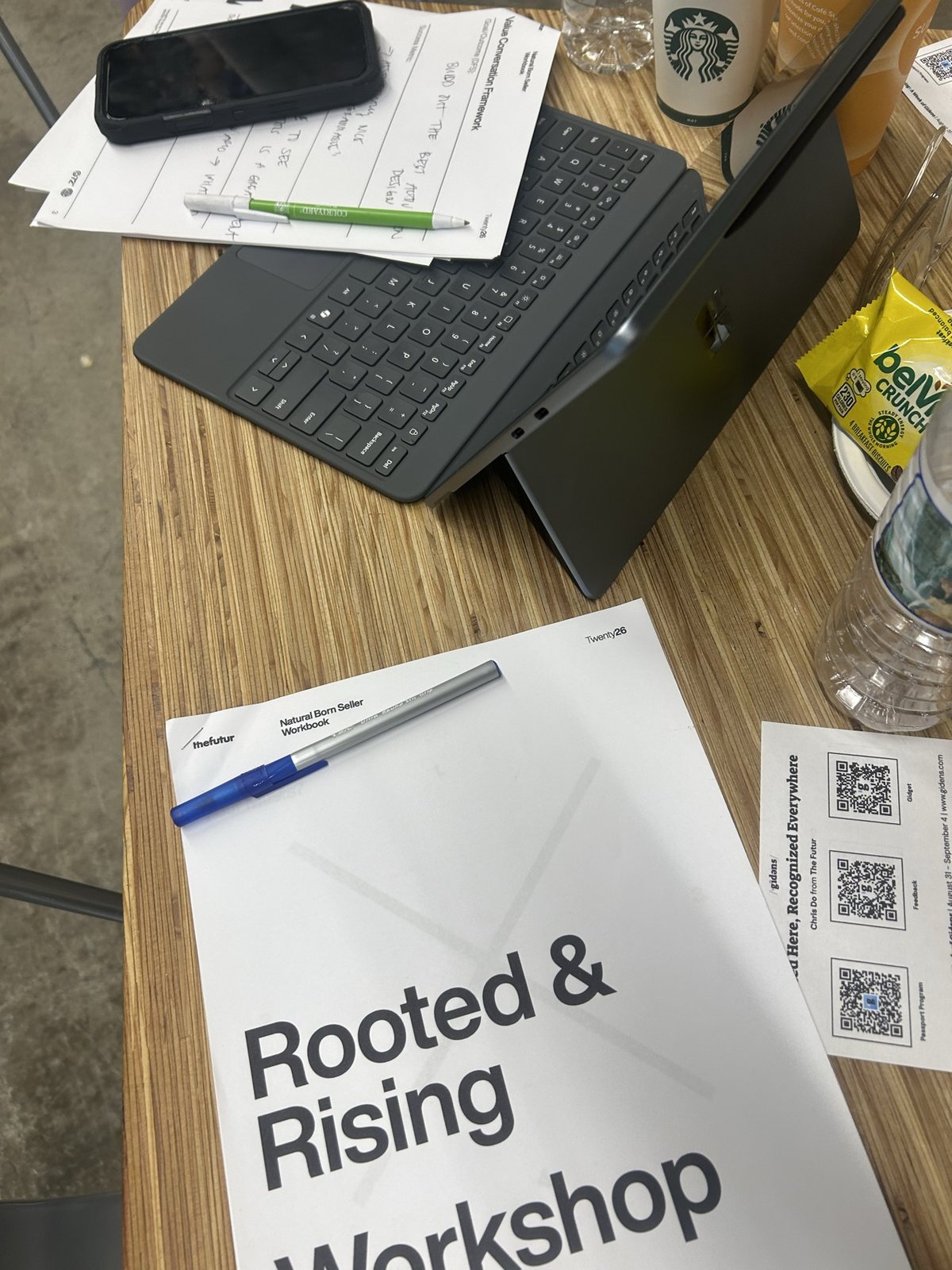 A Rooted & Rising workbook and a card of QR codes