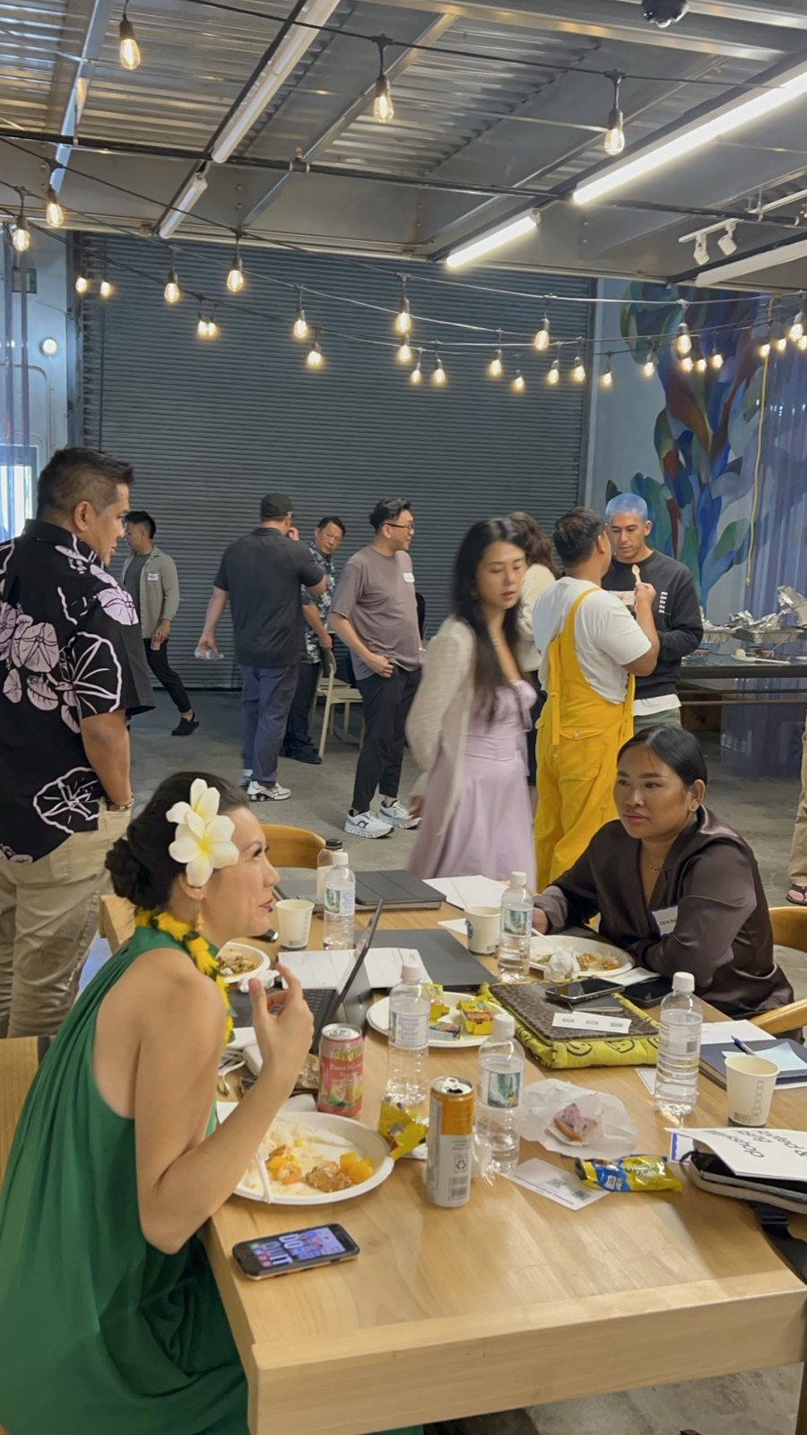 Attendees eating and writing at tables during the break