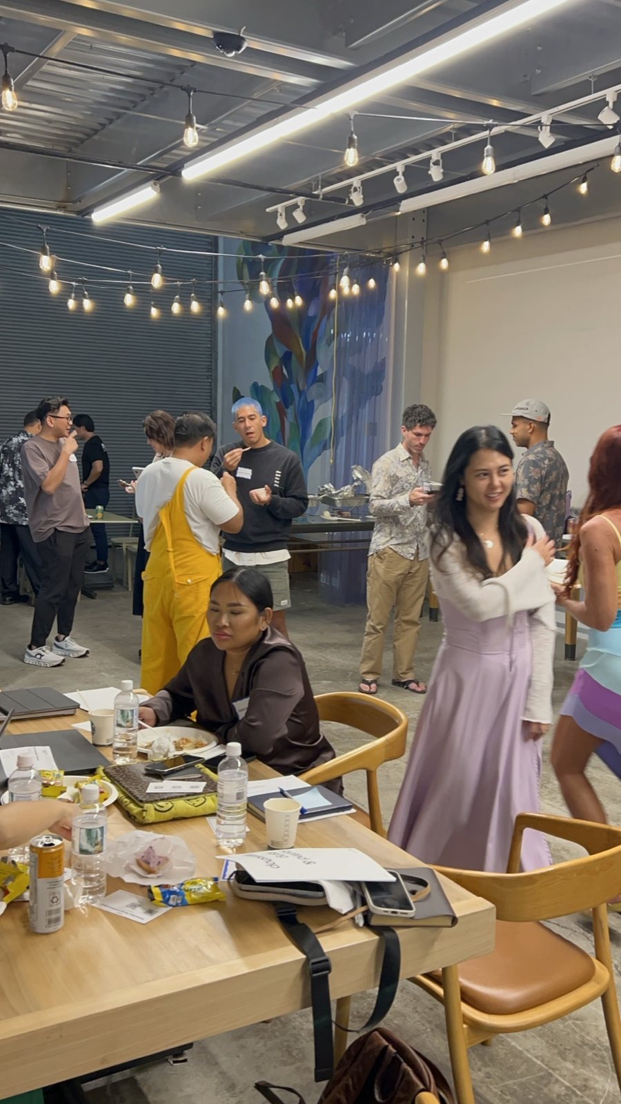 Attendees at tables under string lights