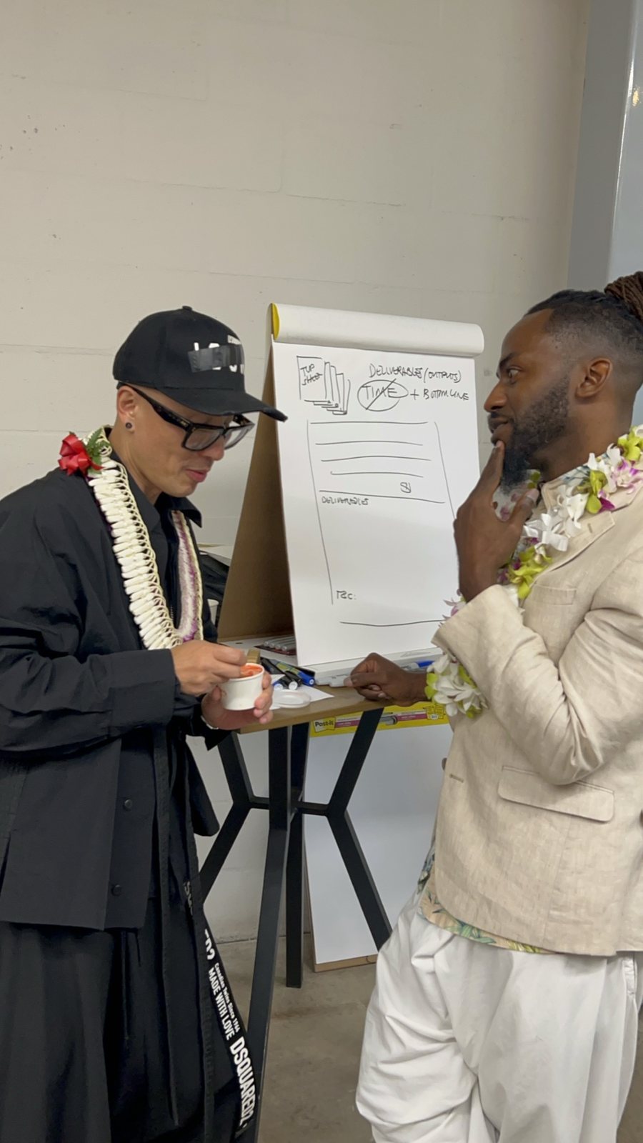 Chris Do beside a flip chart with a guest