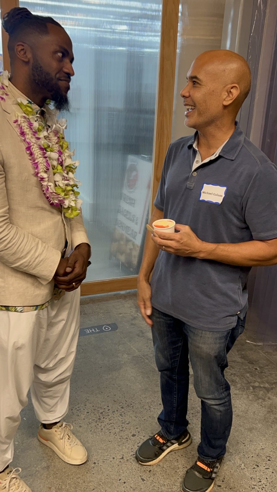 Two men talking by a frosted-glass door