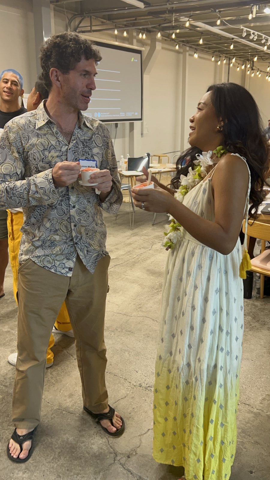 A man and a woman talking over refreshments