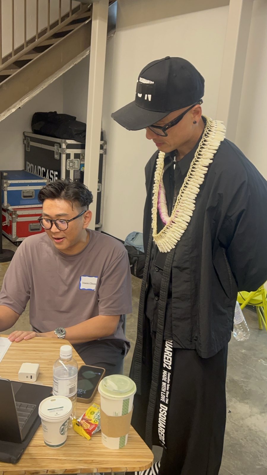 Chris Do standing beside a seated attendee