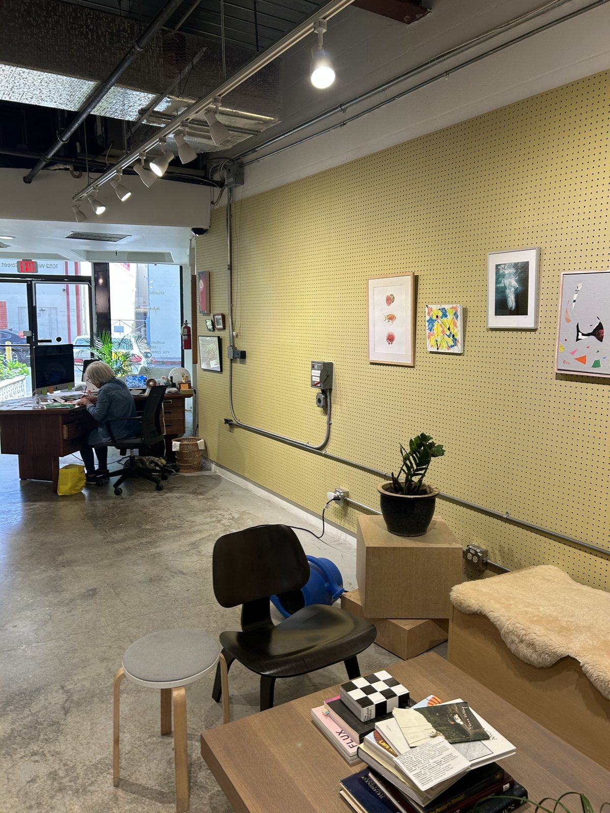 A creative-lab corner with a daybed, books and framed prints
