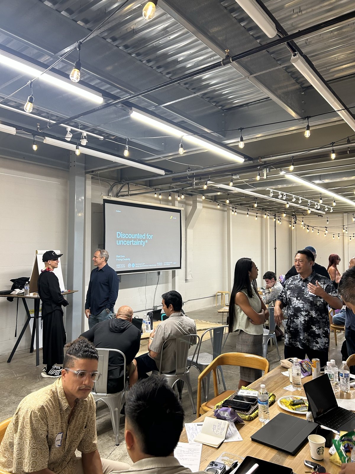 The workshop room: Chris Do at the front, attendees at tables