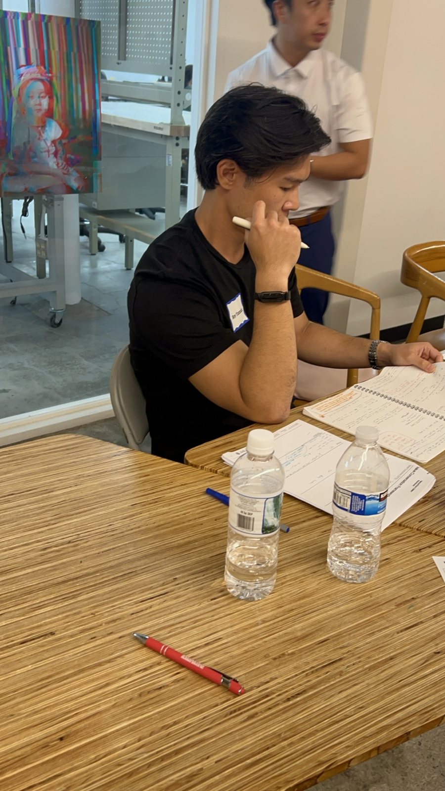 An attendee taking notes at a table