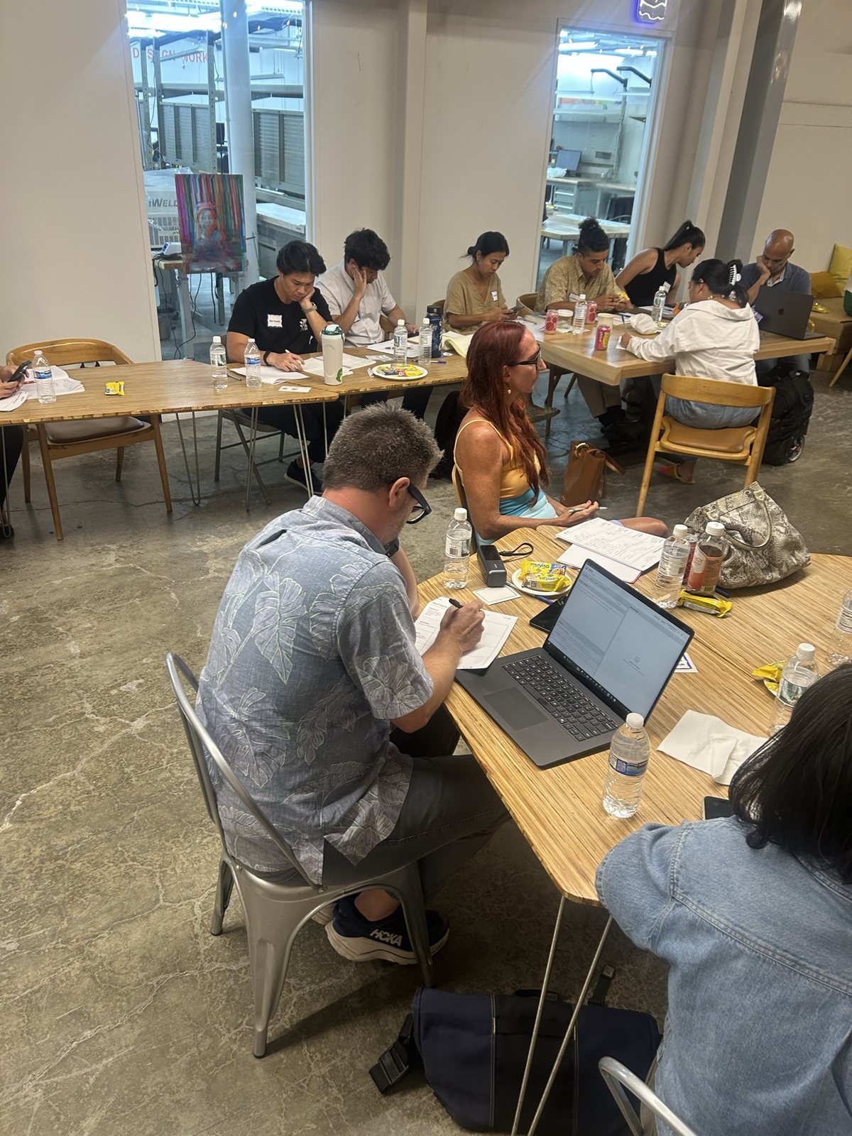 Attendees at a table with worksheets