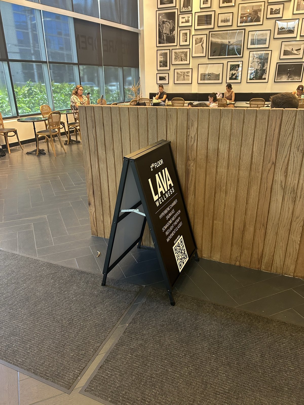 A Lava Wellness A-frame sign beside the counter