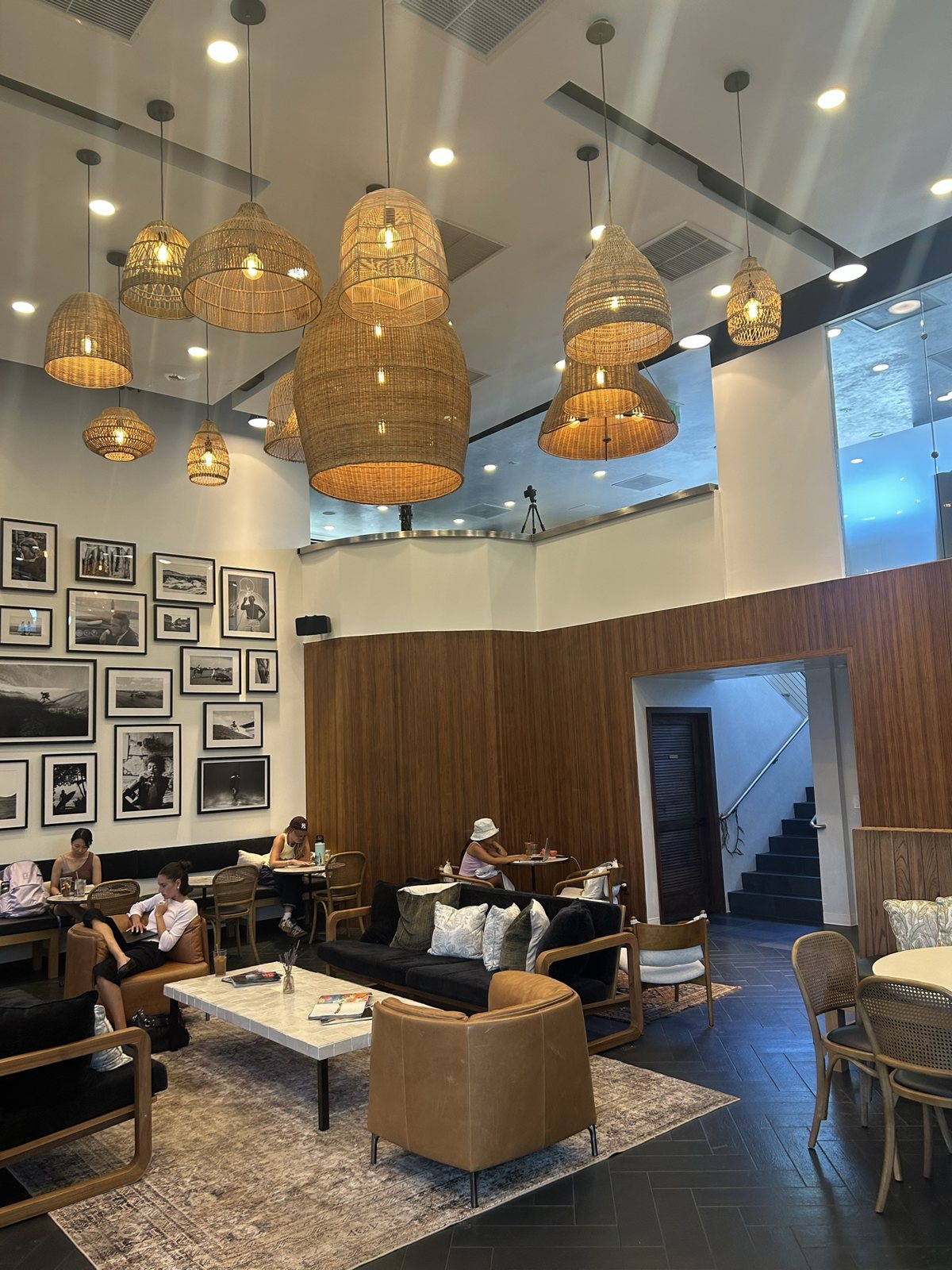 The lounge: sofas, a coffee table and a wall of framed photos