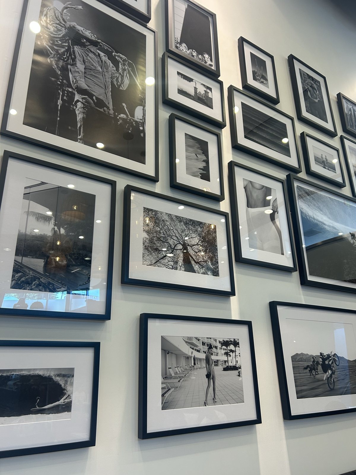 A wall of framed black-and-white photographs