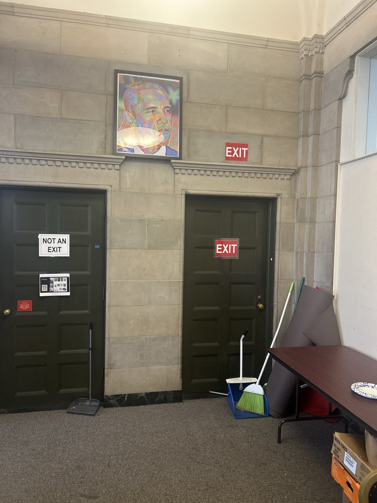 Two dark doors in a stone hallway