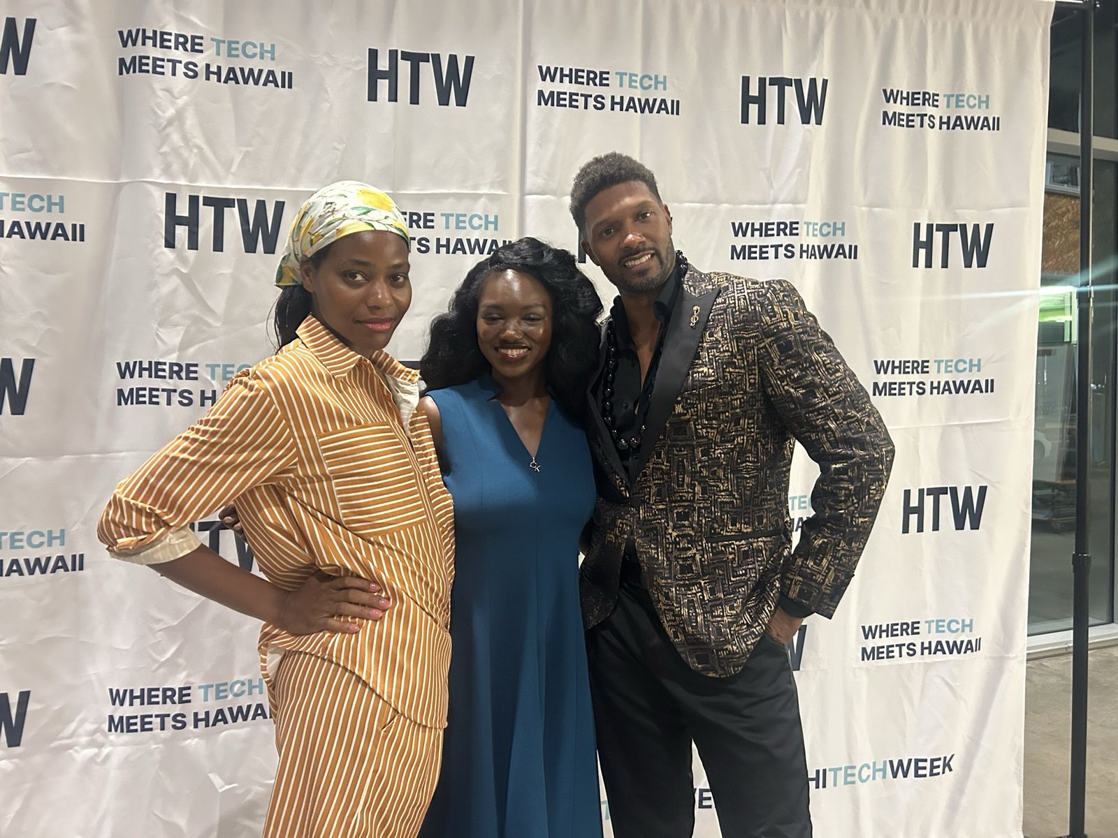 Three guests at the HTW step-and-repeat