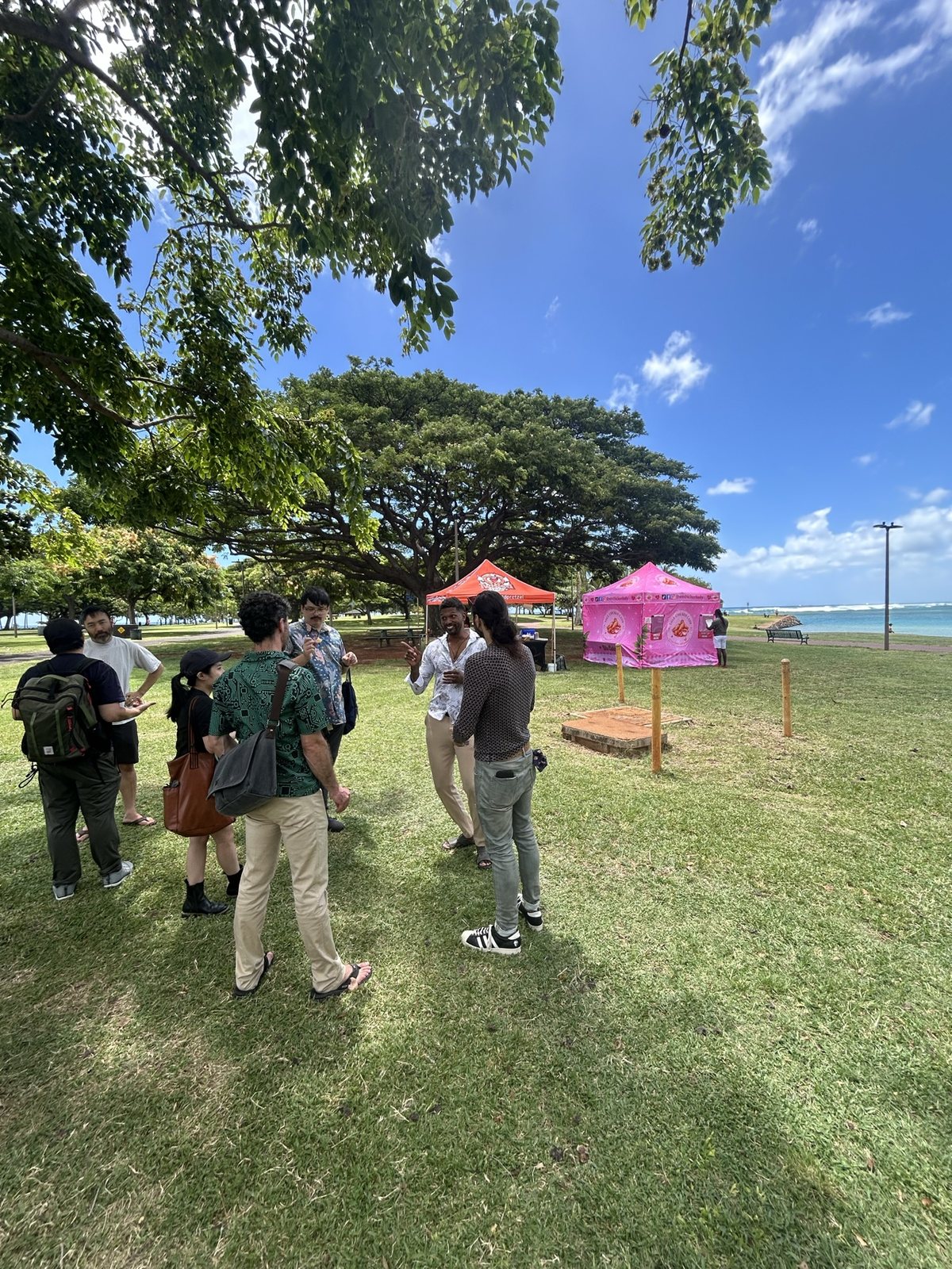 Attendees on the lawn, the tents in the background